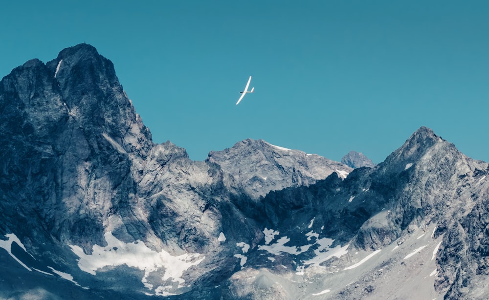 a plane is flying over a mountain range