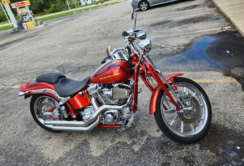 a red motorcycle parked in a parking lot