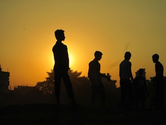 Sunset over the Malagasy landscape with silhouettes of people walking home after a day of work.