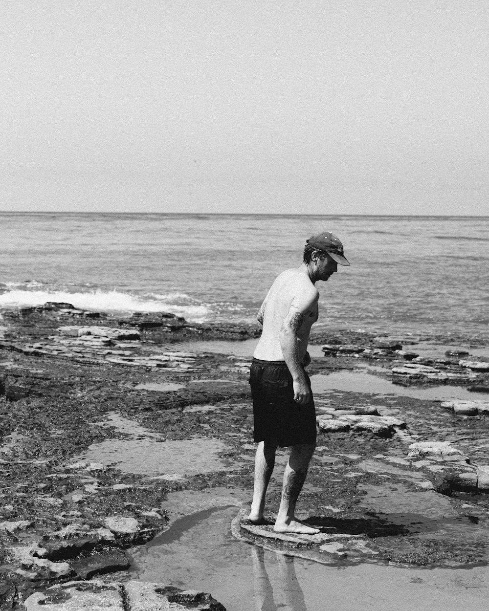 a man standing on a rock near the ocean
