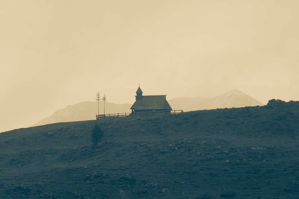 a house on a hill with a sky background