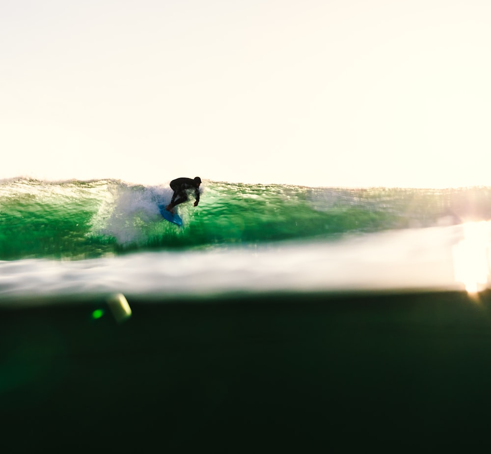 a man riding a wave on top of a surfboard