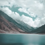 A tranquil landscape featuring mountains and a calm lake.
