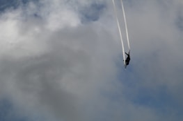 Modern fighter jet soaring above clouds during a training exercise.