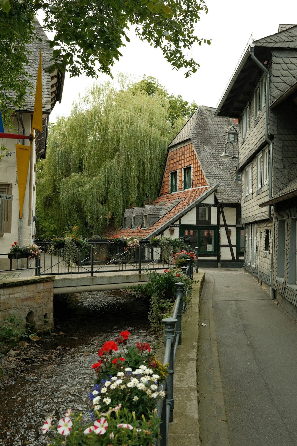 a river running through a small town next to a bridge