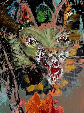 An abstract painting featuring a central cat-like face with intense, wide eyes and an open mouth, possibly with fangs. The strokes are bold and chaotic, using a mix of greens, reds, and browns. The surrounding area features abstract shapes and colors, giving the image a slightly menacing or eerie quality.