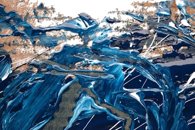 An abstract acrylic painting bursting with swirling blues and golds.