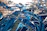 Close-up of a vibrant abstract painting with swirling blues and golds.