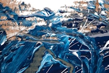 A vibrant abstract painting with swirling patterns of blue, white, and gold. The textures appear thick, with intense brush strokes and dynamic movement, giving a sense of flowing water or waves.