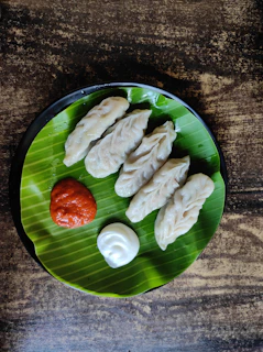 Vibrant red and golden hues of dumplings served on a minimalist blue plate reflecting the brand colors.