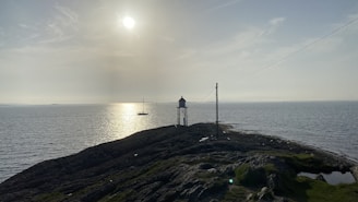 A serene lighthouse shining over calm waters symbolizing guidance and safety.