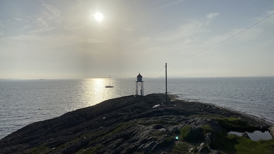 A serene lighthouse shining over calm waters symbolizing guidance and safety.