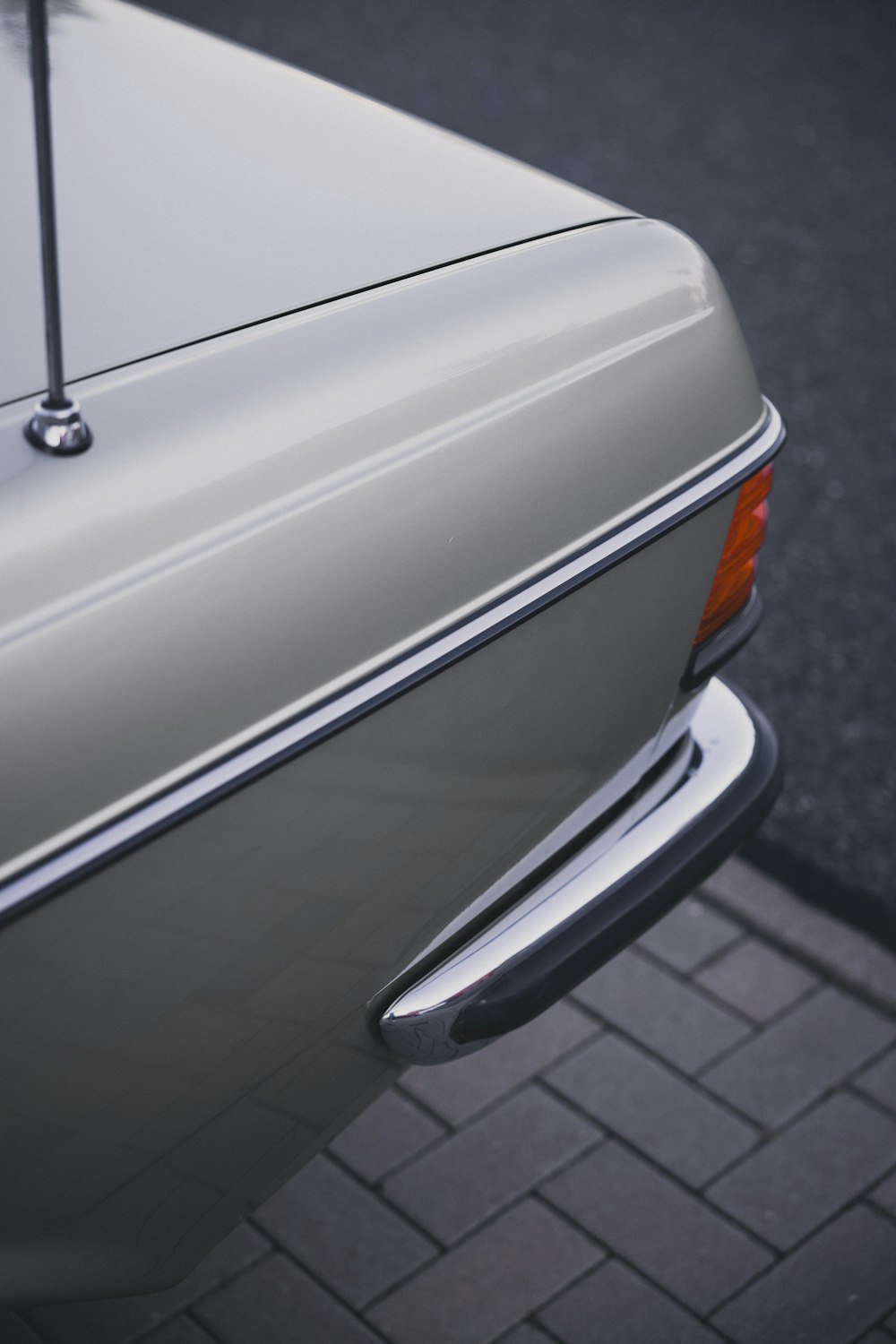 the rear end of a car parked on the side of the road