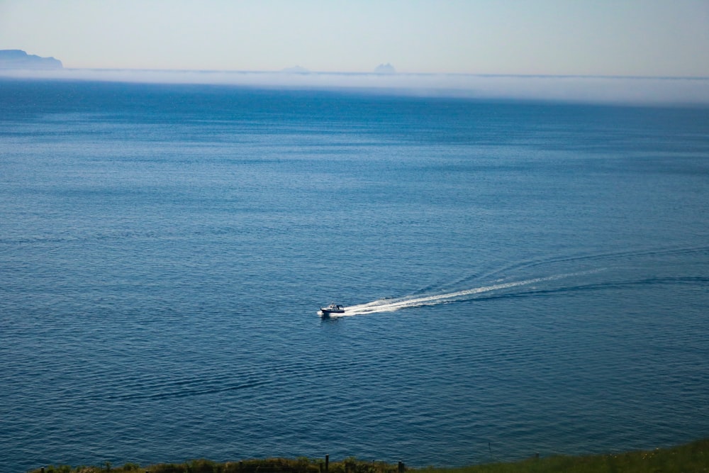 a boat is out in the ocean on a sunny day