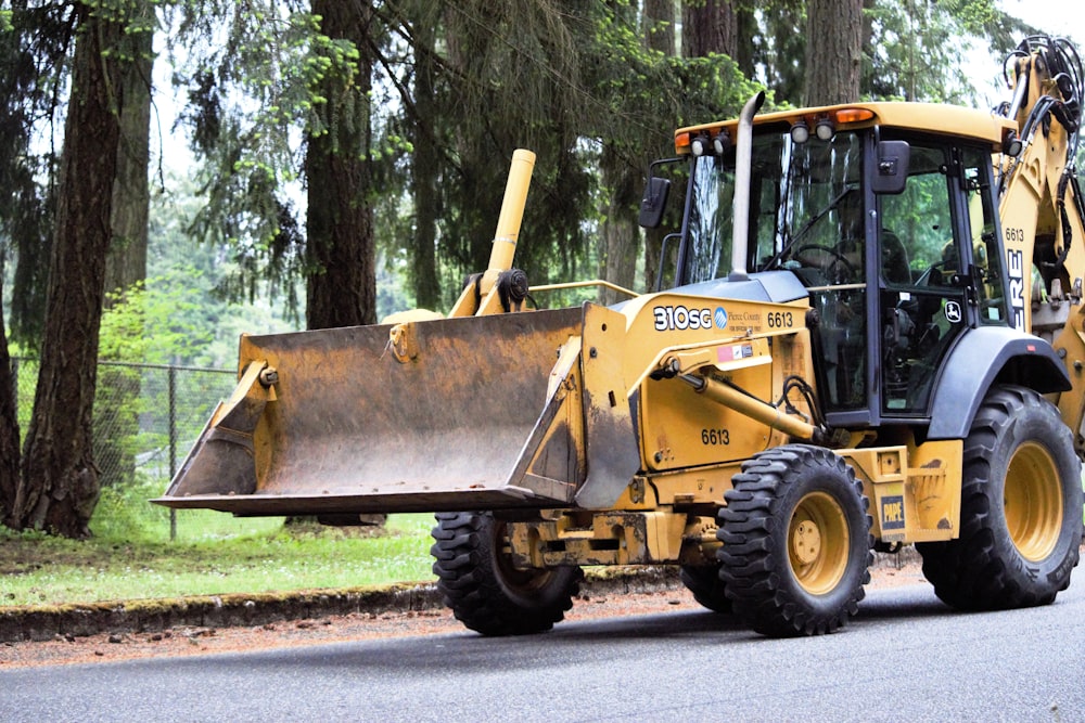 a yellow bulldozer is parked on the side of the road