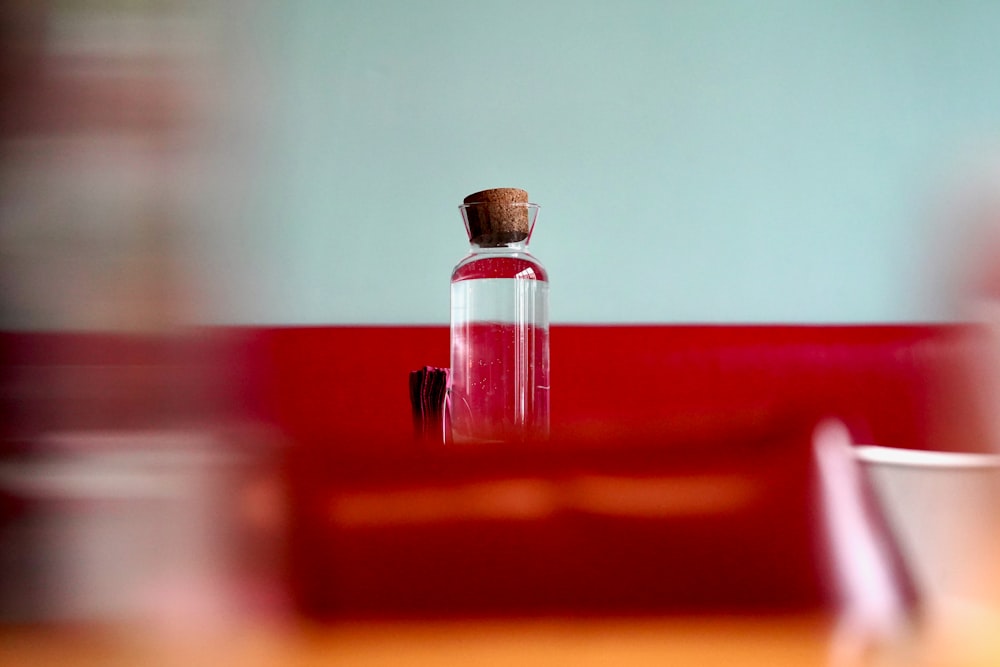 a bottle of wine sitting on top of a wooden table