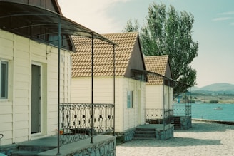 A row of charming tiny houses nestled among trees in the Portuguese countryside.