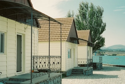 A row of charming tiny houses nestled among trees in the Portuguese countryside.