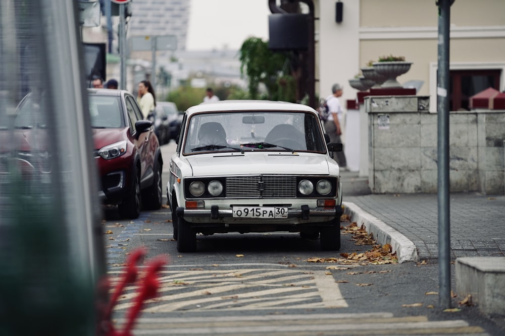 a white car parked on the side of the road