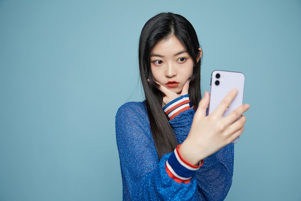 a woman taking a selfie with her cell phone