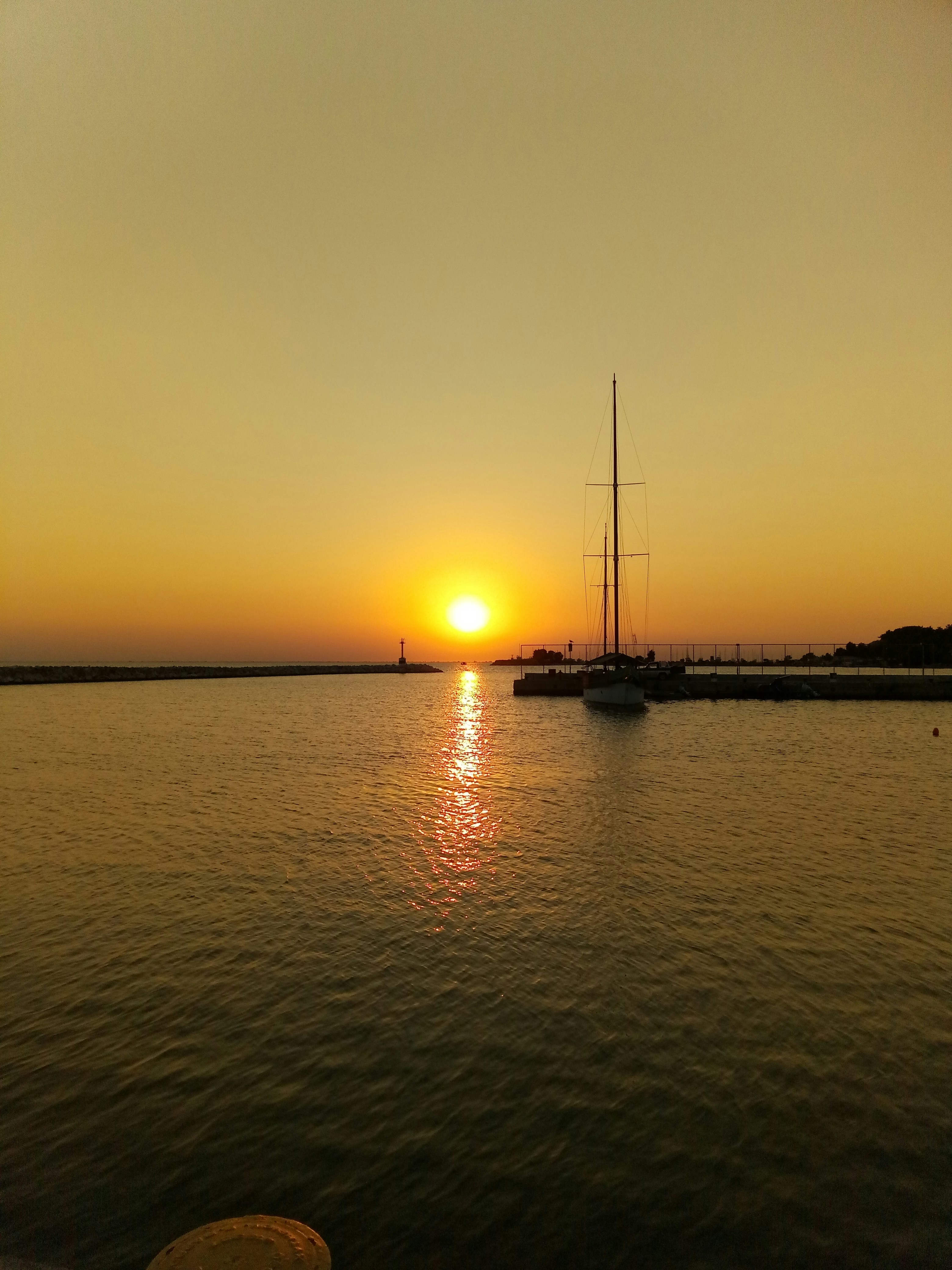 the sun is setting over a large body of water