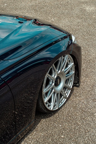 Side profile of a vehicle with gleaming wheels and perfectly polished tires.