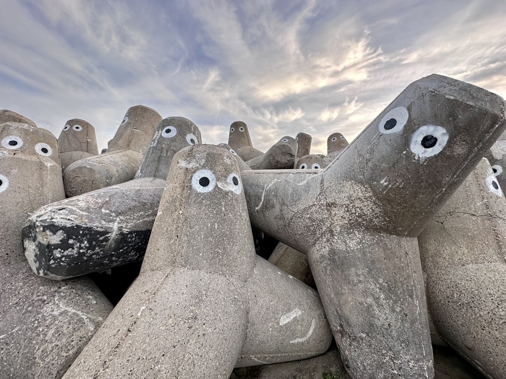 a group of rocks with eyes painted on them