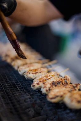 Close-up of perfectly grilled chicken skewers glazed with a tangy barbecue sauce.