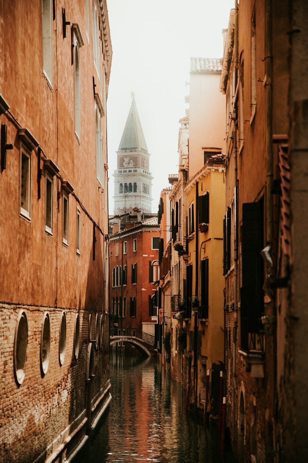 a narrow canal runs between two buildings in a city