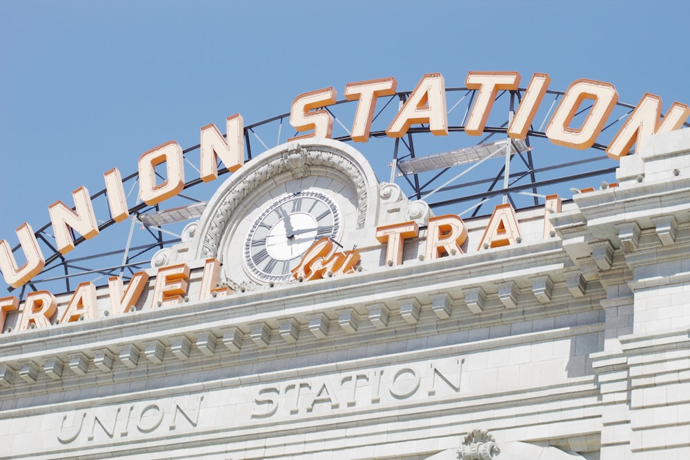 the union station sign has a clock on it