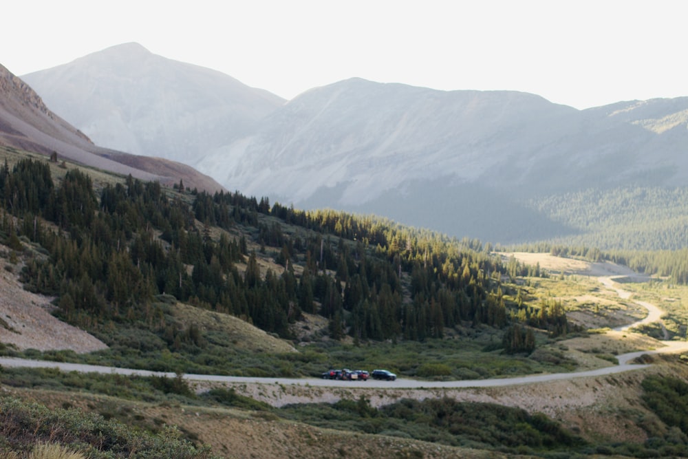 a car driving down a winding road in the mountains