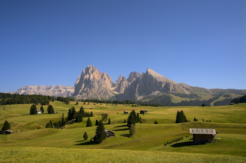 a scenic view of a mountain range with a bench in the foreground