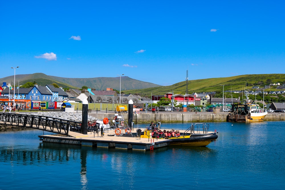 a boat is docked at a pier in the water