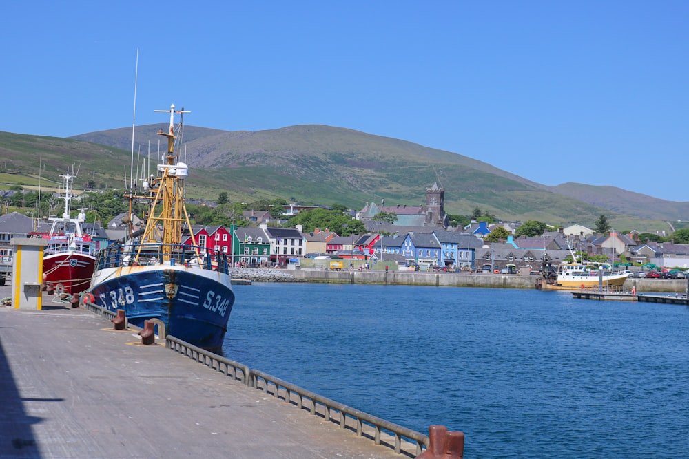 two boats docked at a pier in a harbor