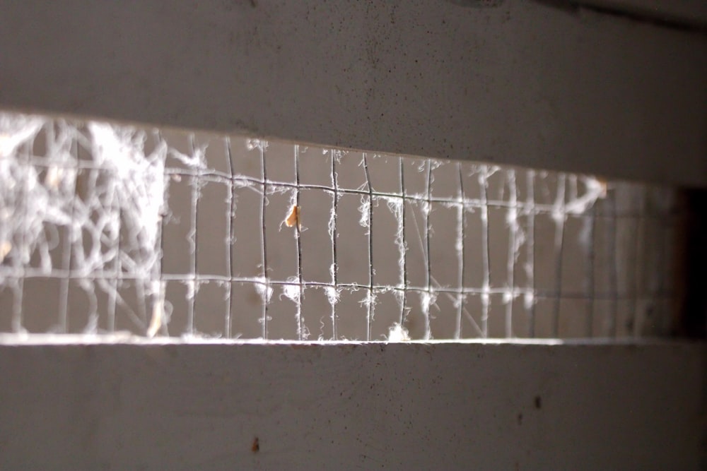 a close up of a metal grate on a wall