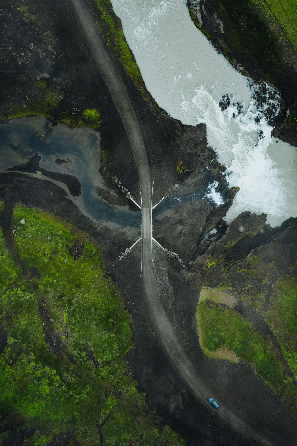 an aerial view of a road and a river