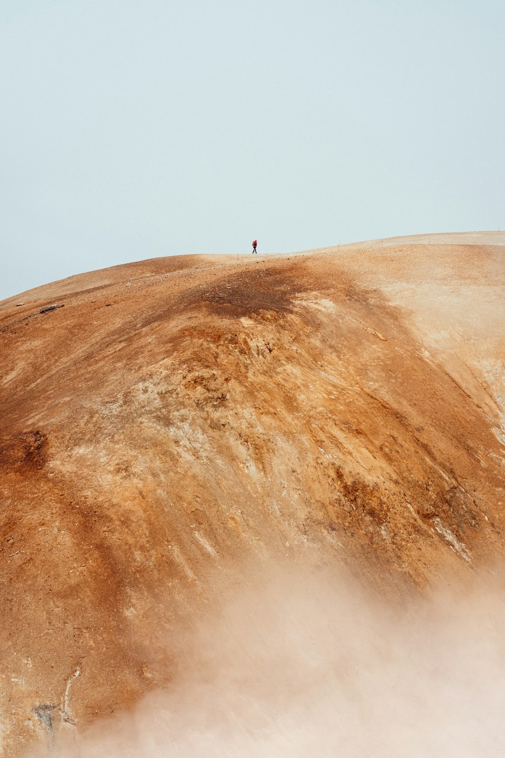 Una persona sola in piedi sulla cima di una collina