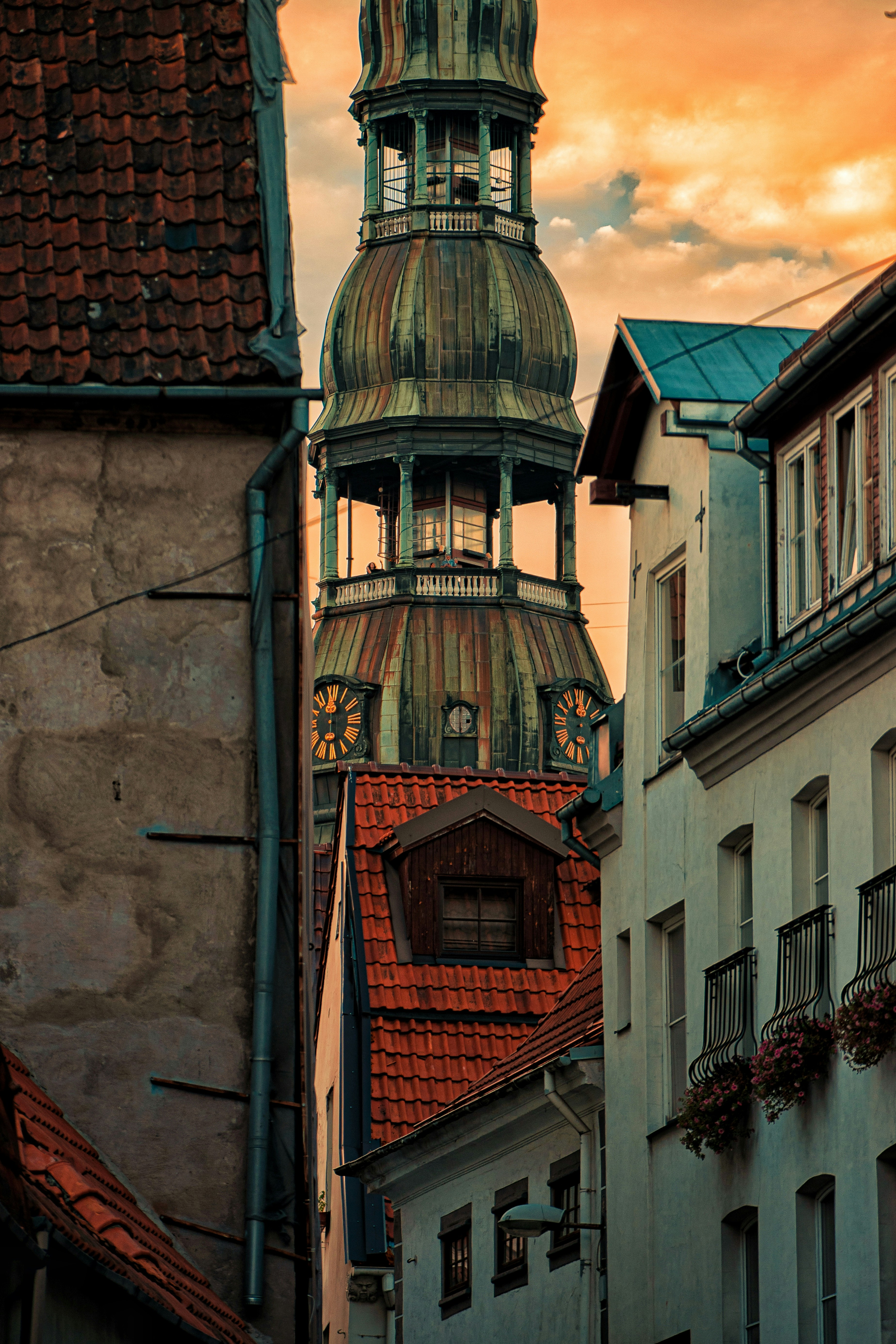 A tall building with a clock on the top of it photo – Free House Image ...
