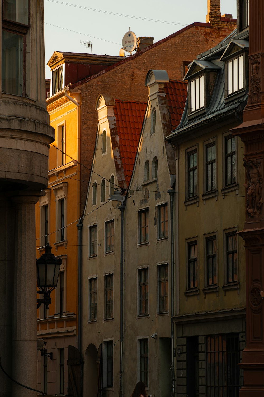 a row of buildings with a clock tower in the background