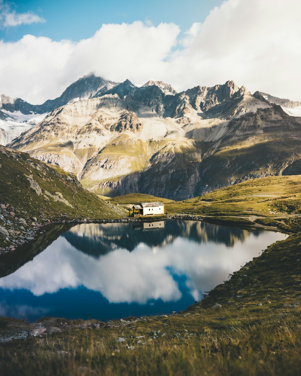 a mountain range with a lake in the foreground