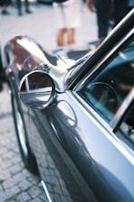 Close-up of a sleek car camera mounted on a windshield with a city street in the background.
