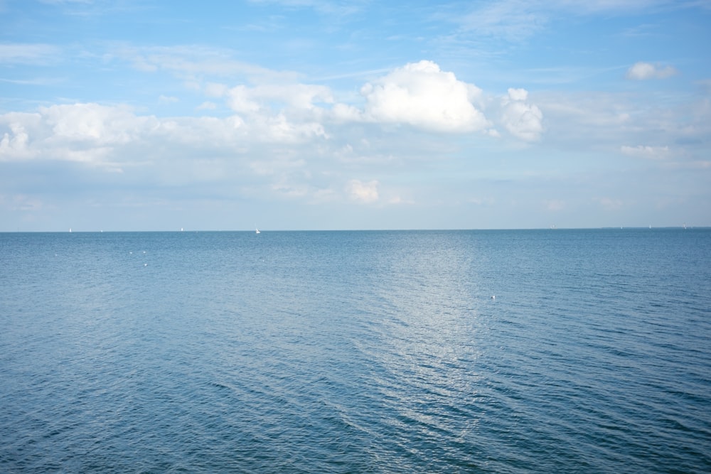 a large body of water with a sky background