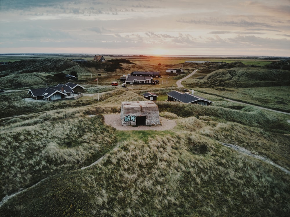 an aerial view of a small building in the middle of a field