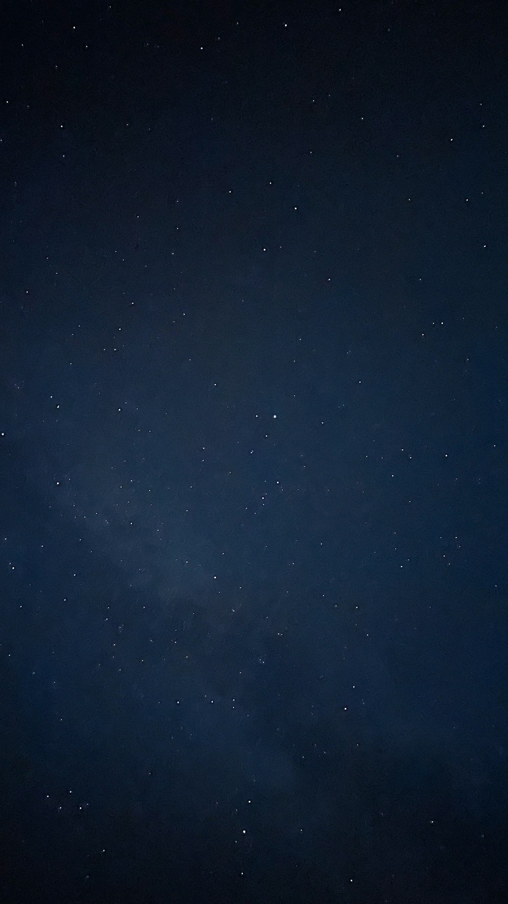 a night sky with stars and a plane in the foreground