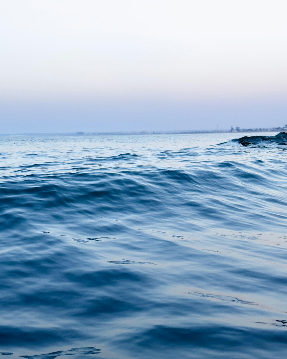 a person riding a surfboard on a wave in the ocean