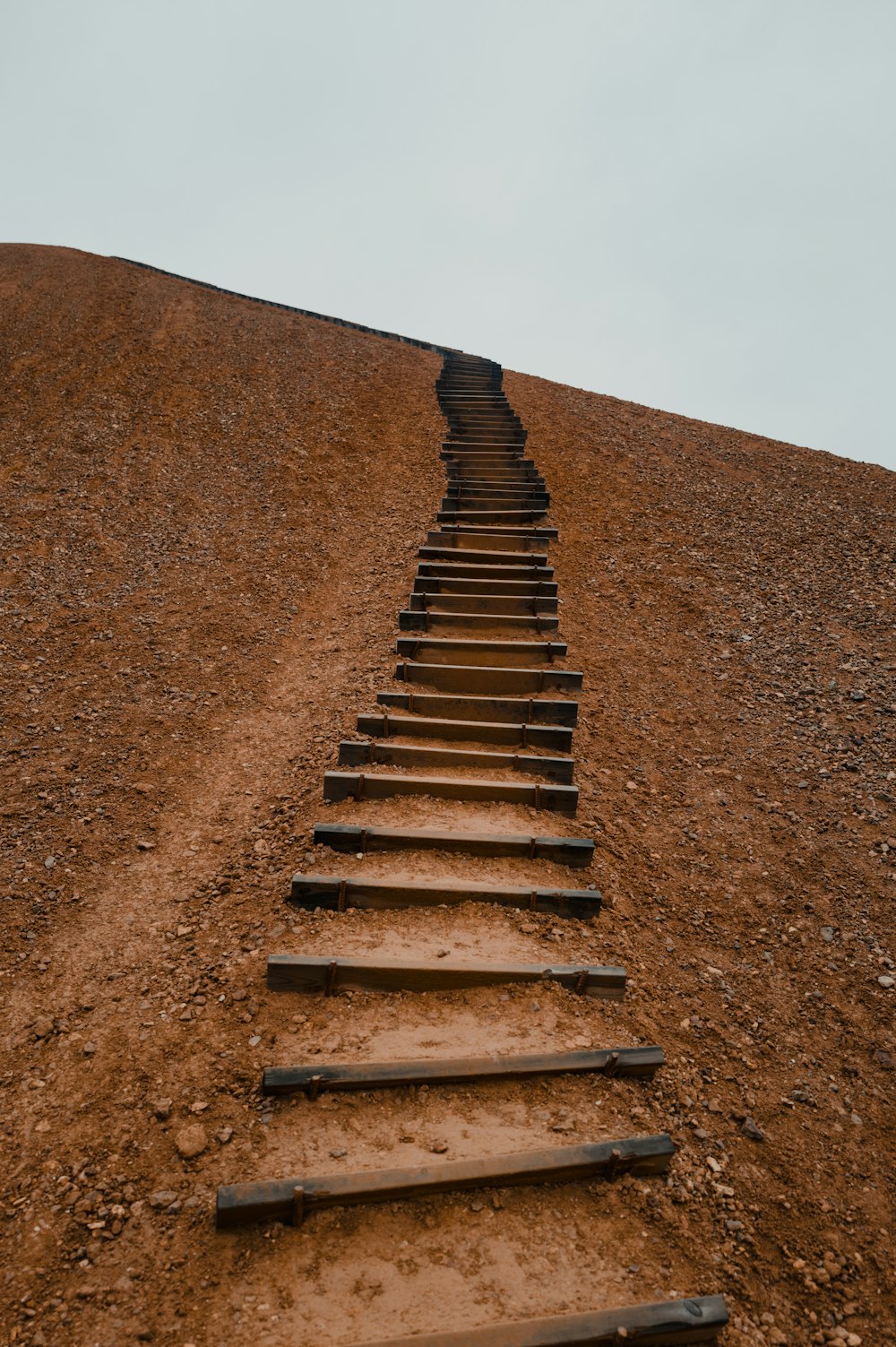 a set of wooden stairs going up a hill