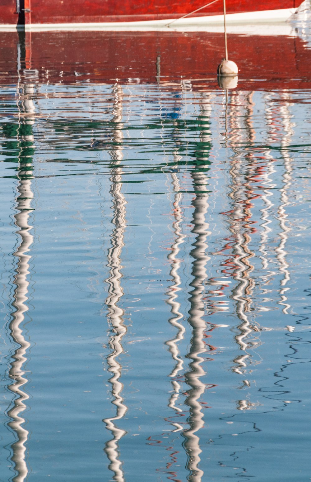 a red boat is sitting in the water