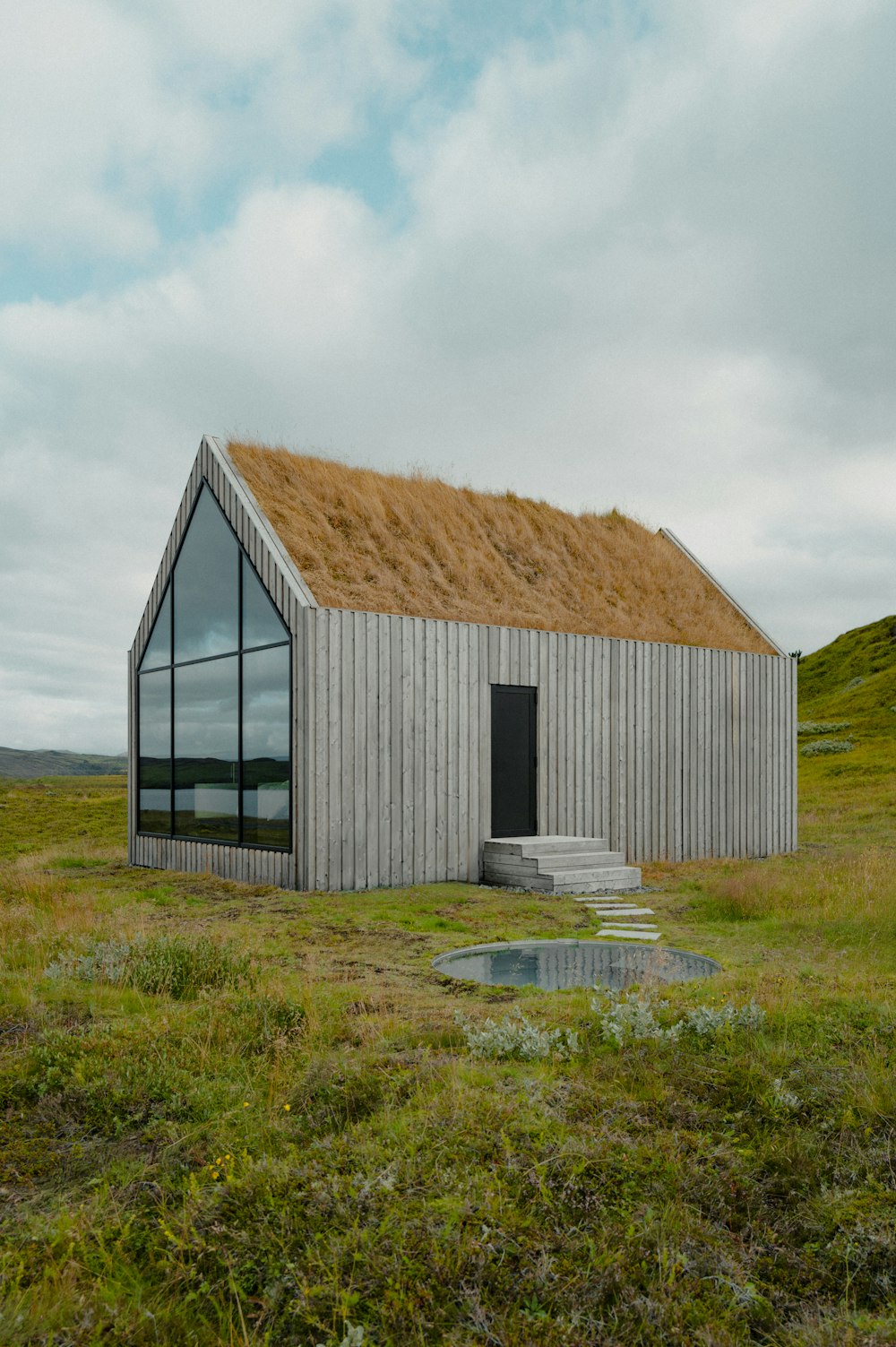 a house with a grass roof and a window