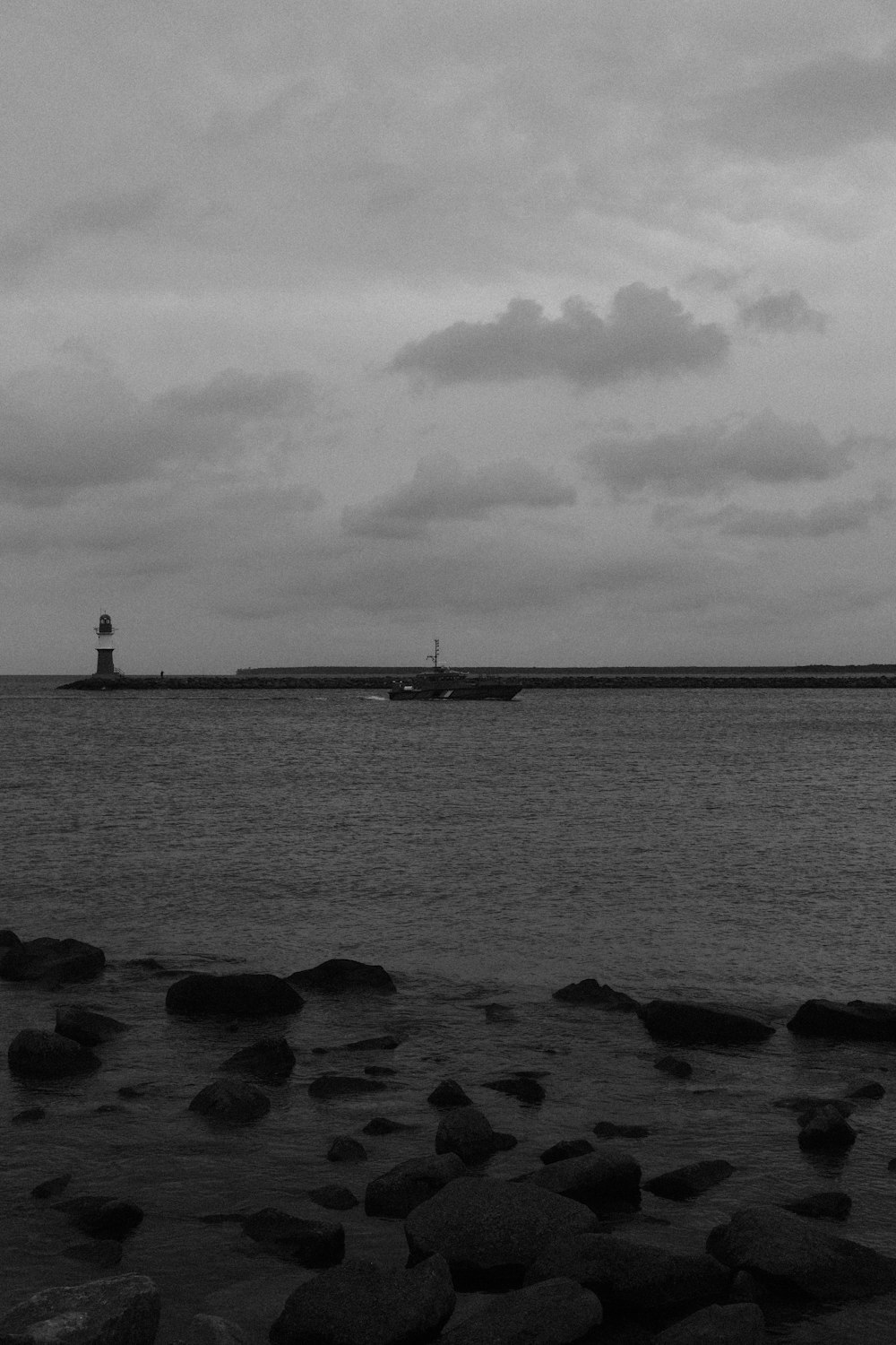 a black and white photo of a boat in the water