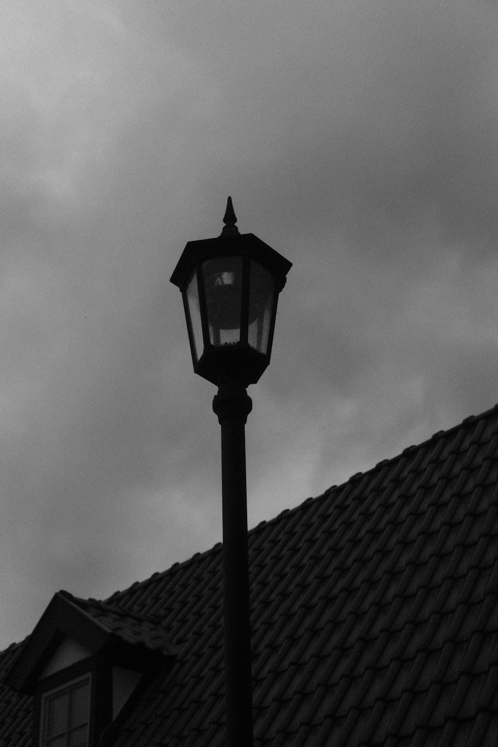 a black and white photo of a street light